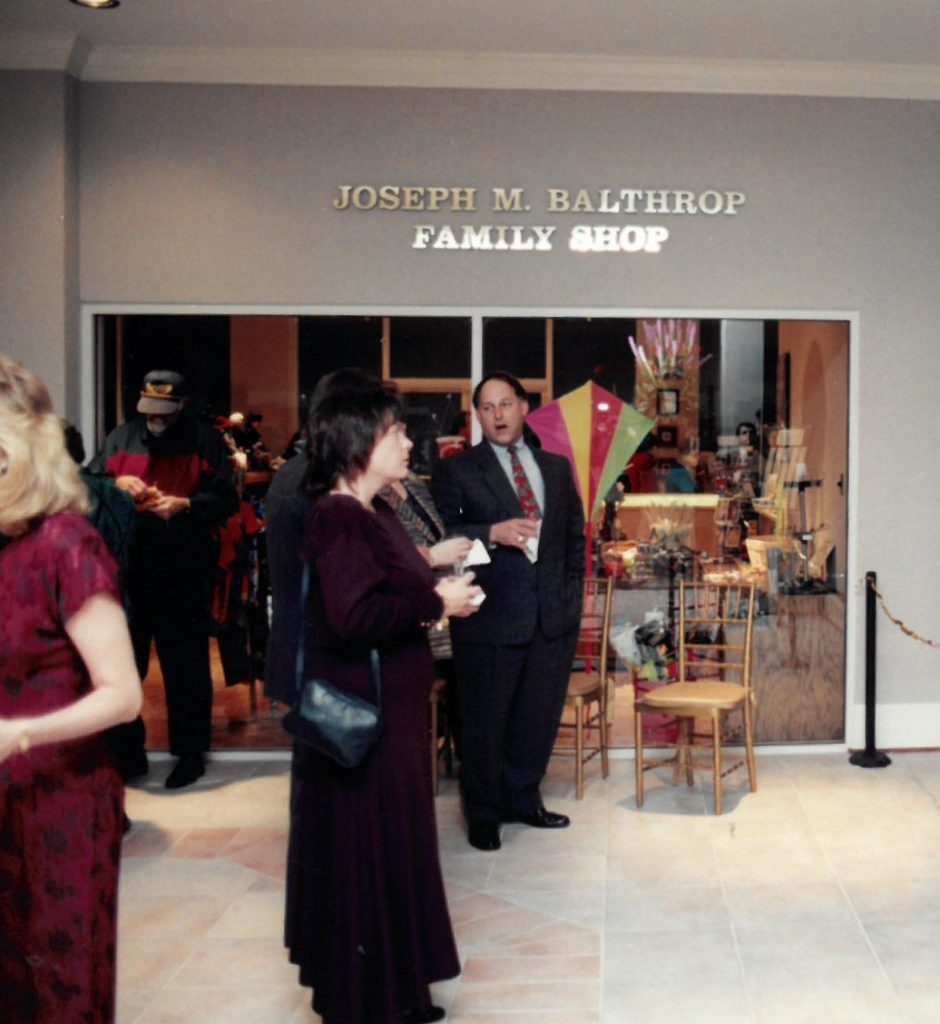 Opening reception of the 1996 building opening. Visitors stand in the Museum lobby outside the Joseph M. Balthrop Family Shop.