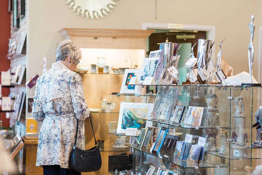 Shopper browses items in Seasons: The Museum Store.