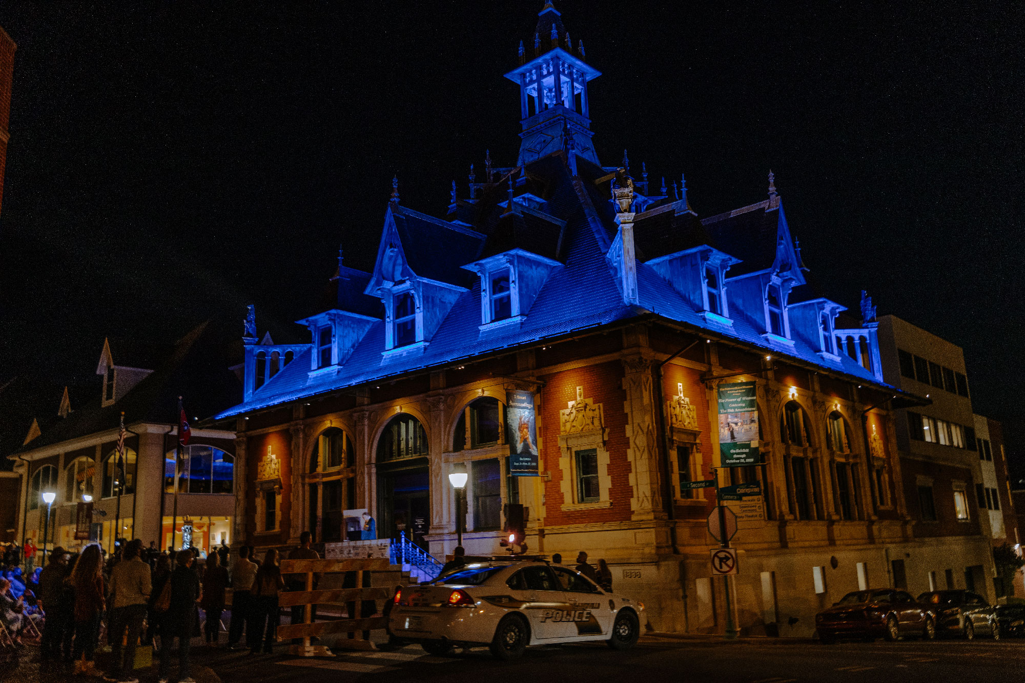 The Customs House Museum & Cultural Center illuminated in blue for the crowd.