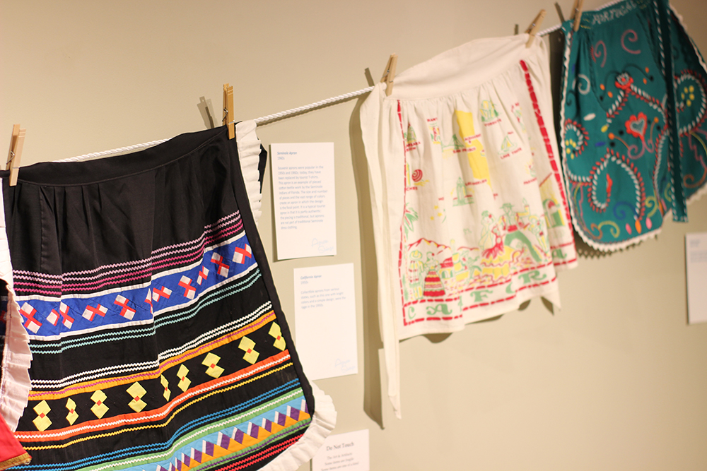 Colorful aprons hanging on wall in gallery at the Customs House Museum.