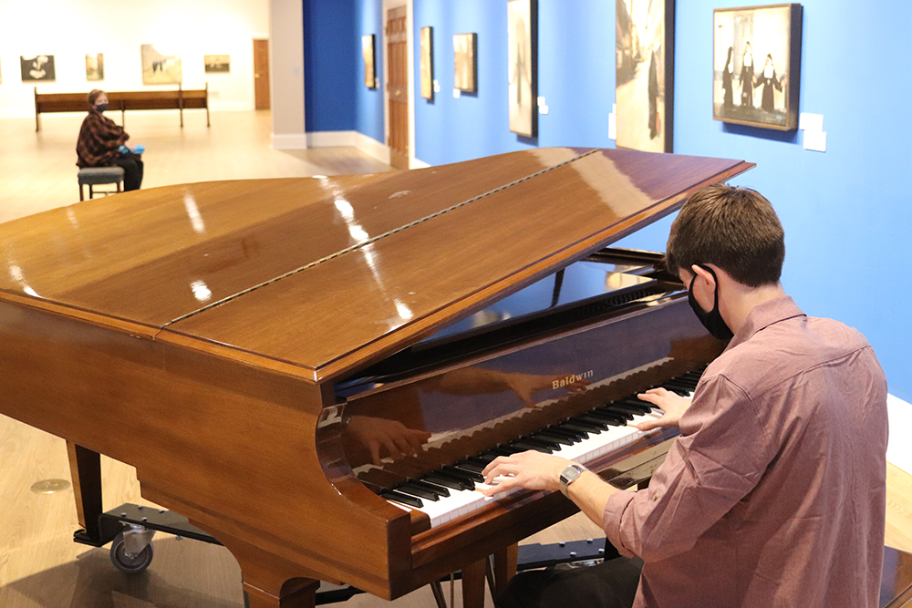 Pianist adds ambient music in the Orgain Gallery as Museum guests filter through from Noel Night. 