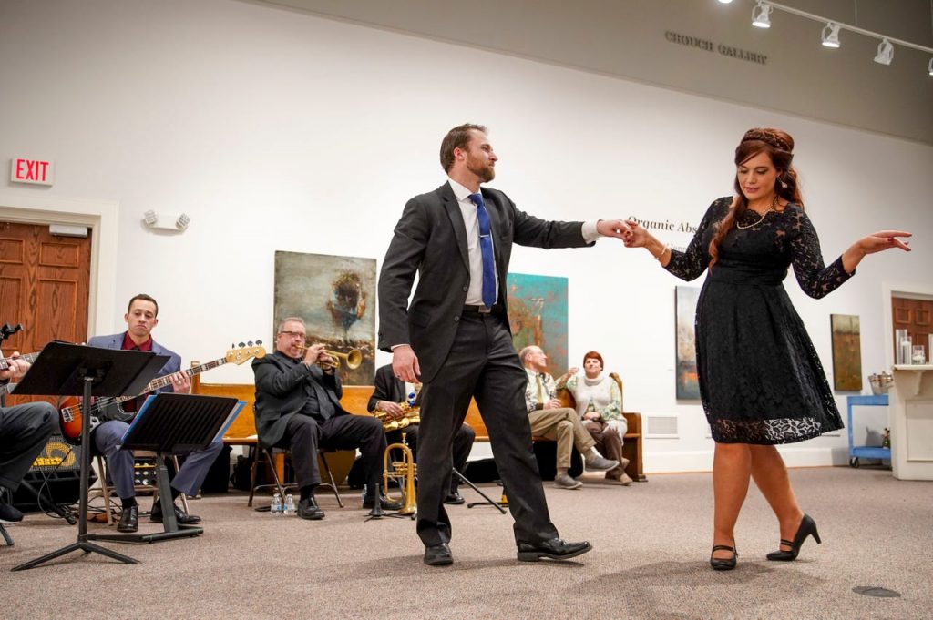 Museum guests dance in front of a live band in the Crouch Gallery during Champagne & Chocolate.