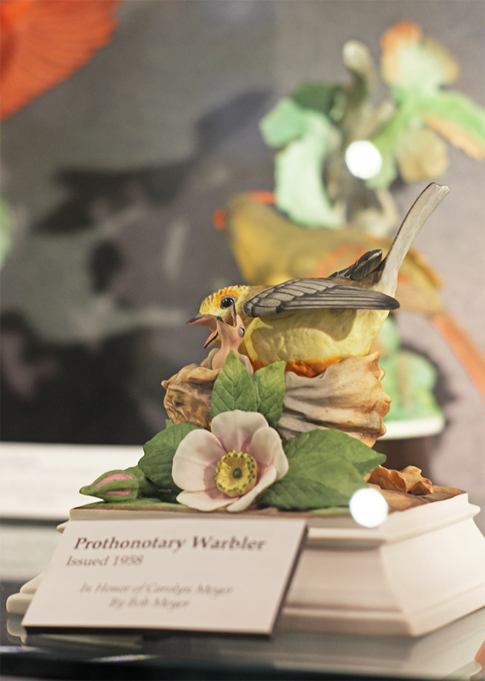 Porcelain mother and baby bird sitting in a nest Boehm sculpture. The sculpture is entitled 'Prothonotary Warbler' issued 1958. 