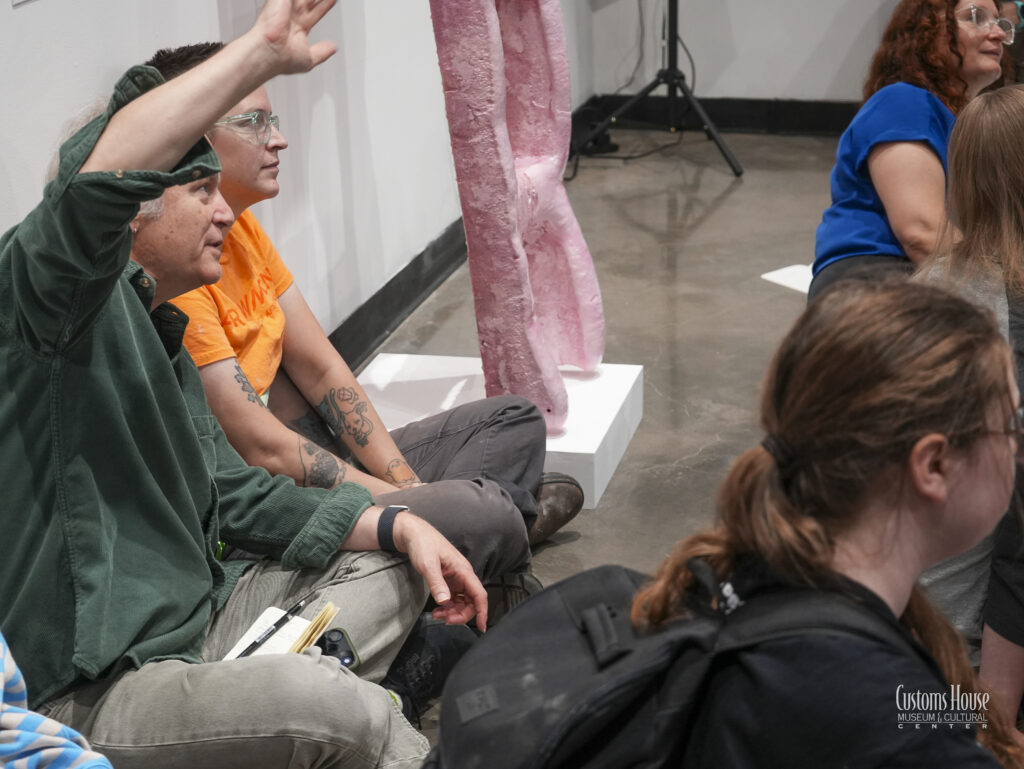Professor Billy Renkl seen here raising his hand during the gallery talks on Sept. 10, 2026, at the New Gallery for "Spark" Exhibition. (D.C. Thomas/Customs House Museum & Cultural Center)