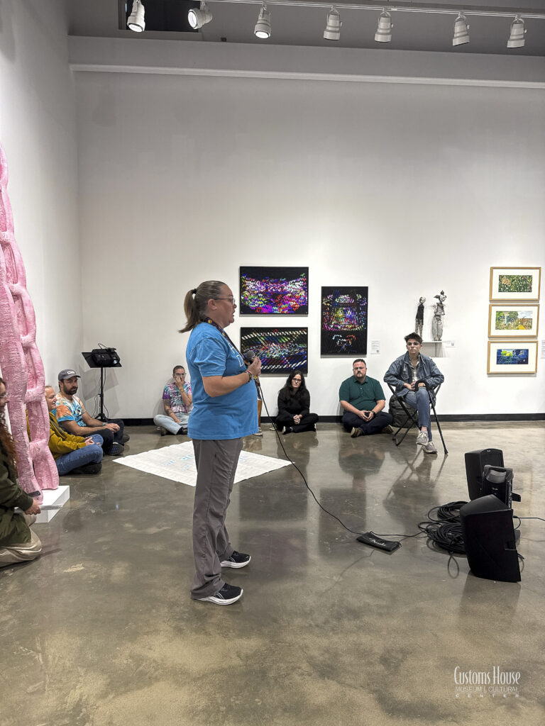 Tabitha Sweitzer describing her photography experiences and exhibited works during the Spark Exhibition at the New Gallery on Sept. 24, 2026. D.C. Thomas/Customs House Museum & Cultural Center
